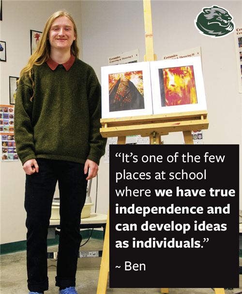 Wood River High School student standing next to his artwork 